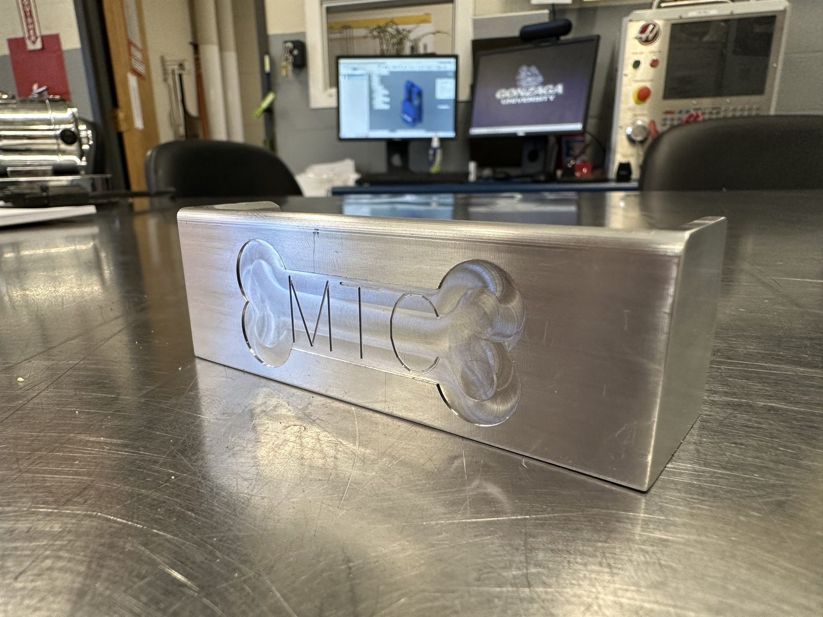 The underside, engraved with the Herak Manufacturing Technology Center mark.