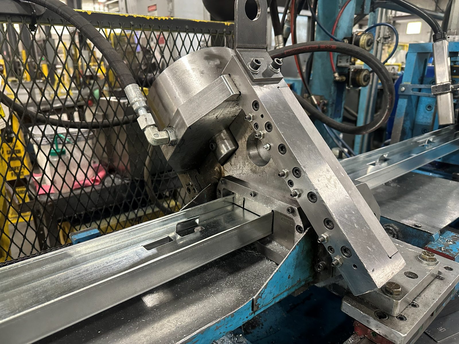 A formed stud leaving the shear at the end of the roll forming line.